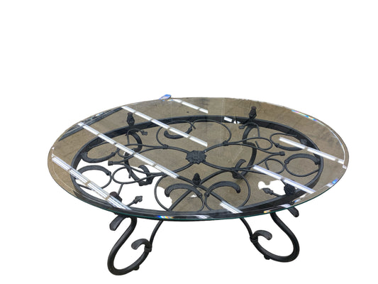 Oval beveled glass coffee table on ornate cast-iron base, 47.5x31.75x18"
