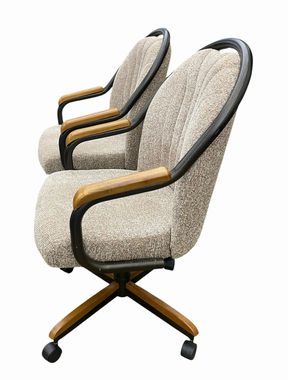 Pair of upholstered swivel/tilt rolling armchairs. 37.75H 22.5W 24D