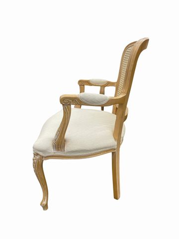 Louis XV-style cane back armchair w/cream upholstery, 34.5H. 25W. 22D.