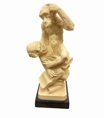 Figurine of monkey pondering Darwin's theory, 8" h