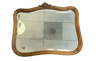 Antique beveled mirror in carved oak frame, 24x19.5"