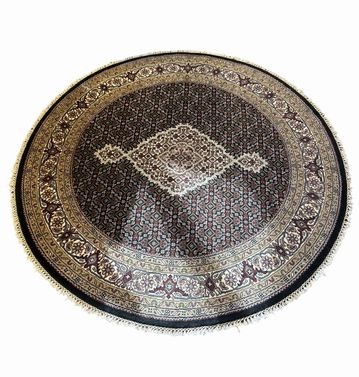 Round brown/cream/black medallion pattern wool rug, 62" diam.